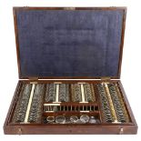 An early 20th century cased set of Optician's lenses, including concave, convex and sphericals,