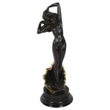 A spelter figure on a base depicting a woman, nude standing in a shell, height including base 34cm