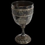 A large Victorian silver chalice, fluted bowl with an embossed band of figures, height 19.5cm,