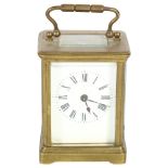 A French brass-cased carriage clock, white enamel dial with Roman numerals and bevelled glass