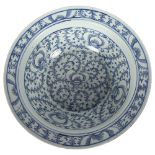 A Chinese Qing Dynasty porcelain basin or bowl, with blue and white scrolling peony decoration,