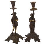 A pair of patinated cast-brass candlesticks with figure supports, 28cm