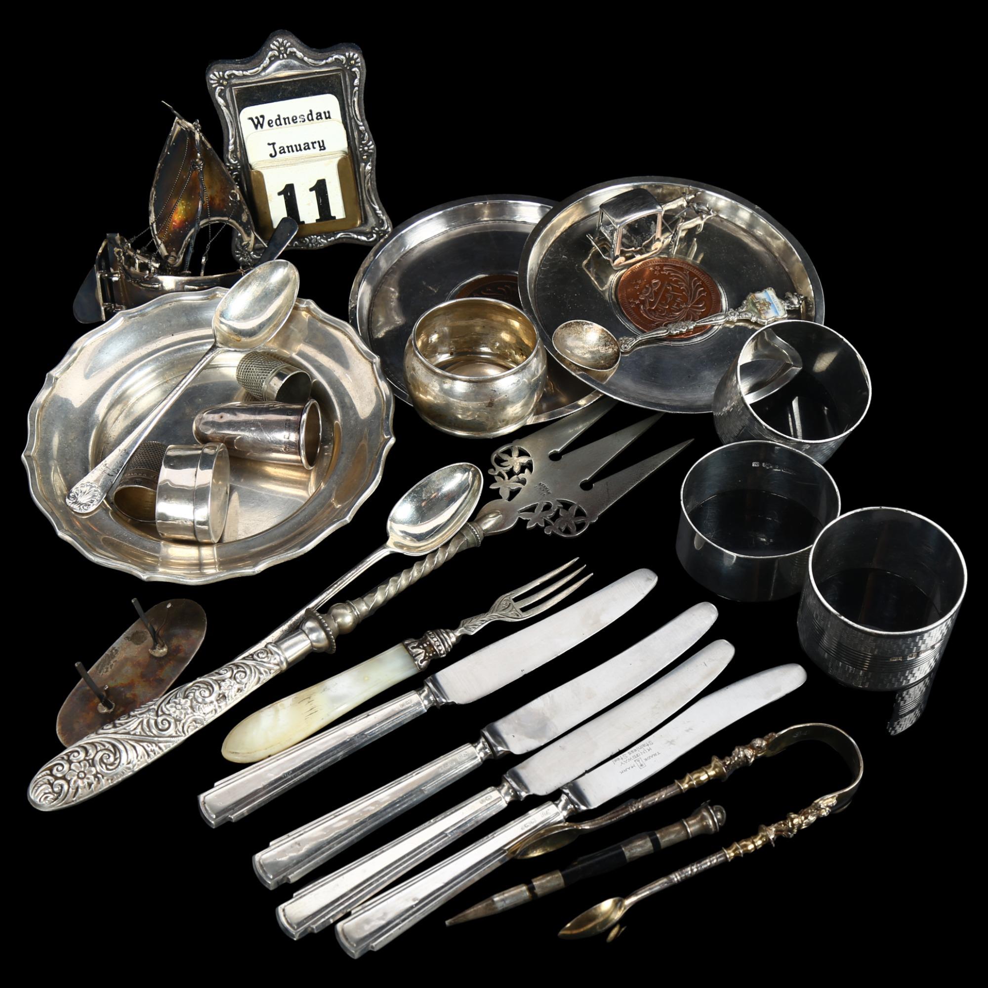 A group of silver items, to include napkin rings, small circular dish, silver-handled knives etc,