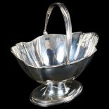 A Victorian silver fluted swing-handled sugar basket, London 1899