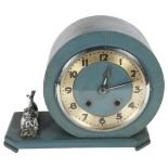 An early 20th century painted mantel clock, with 8-day movement, shaped canted base with figure