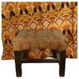 A Liberty's upholstered oak footstool, on H-shaped stretcher, with label to the underside, and a