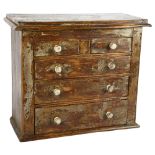 An Antique painted pine table-top chest of 2 short and 3 long drawers, with turned wood handles,