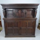 An 18th/19th century two section panelled oak court cupboard with chip carved decoration.