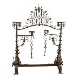 An exceptional late 17th century wrought-iron andiron, the joined pair topped with baskets and