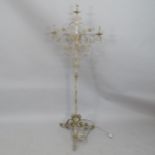 A wrought iron candelabra on tripod base, converted to electric. Height overall 158cm