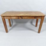 An antique pine plank top kitchen table. 146x74x60cm.