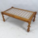 A moorish design rectangular tile-top table, with stained pine frame raised on turned walnut legs.