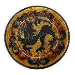 Celtic pottery, Newlyn, Cornwall, a decorative circular dish with stylised lion design, diameter