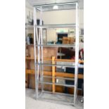 A late 20th century brushed steel frame display stand with toughened glass shelves, height 209cm x