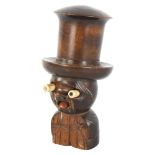 A novelty carved wood and bone dice shaker figure with screw-on hat, containing original bone