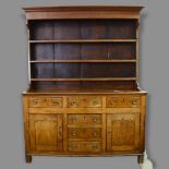 George III oak Welsh dresser, with boarded open plate rack, and drawers and cupboards below, width