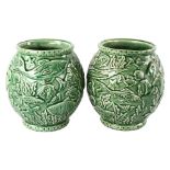 A pair of French green glaze pottery vases, with relief moulded under-sea decoration, height 21cm
