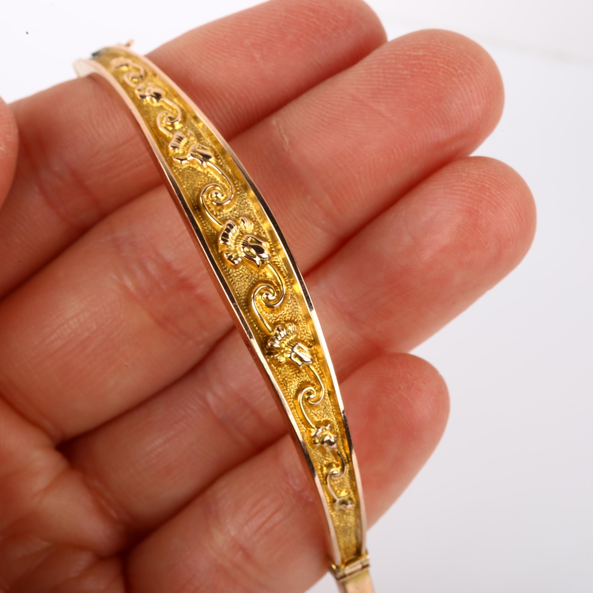 An early 20th century 9ct gold hinged bangle, relief embossed foliate decoration, maker's marks S - Image 4 of 4