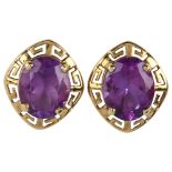 A pair of amethyst earrings, unmarked gold Greek Key design with oval mixed-cut amethyst, earring