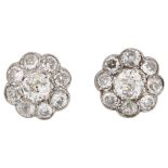 A pair of diamond cluster flowerhead earrings, unmarked white gold settings with old European and