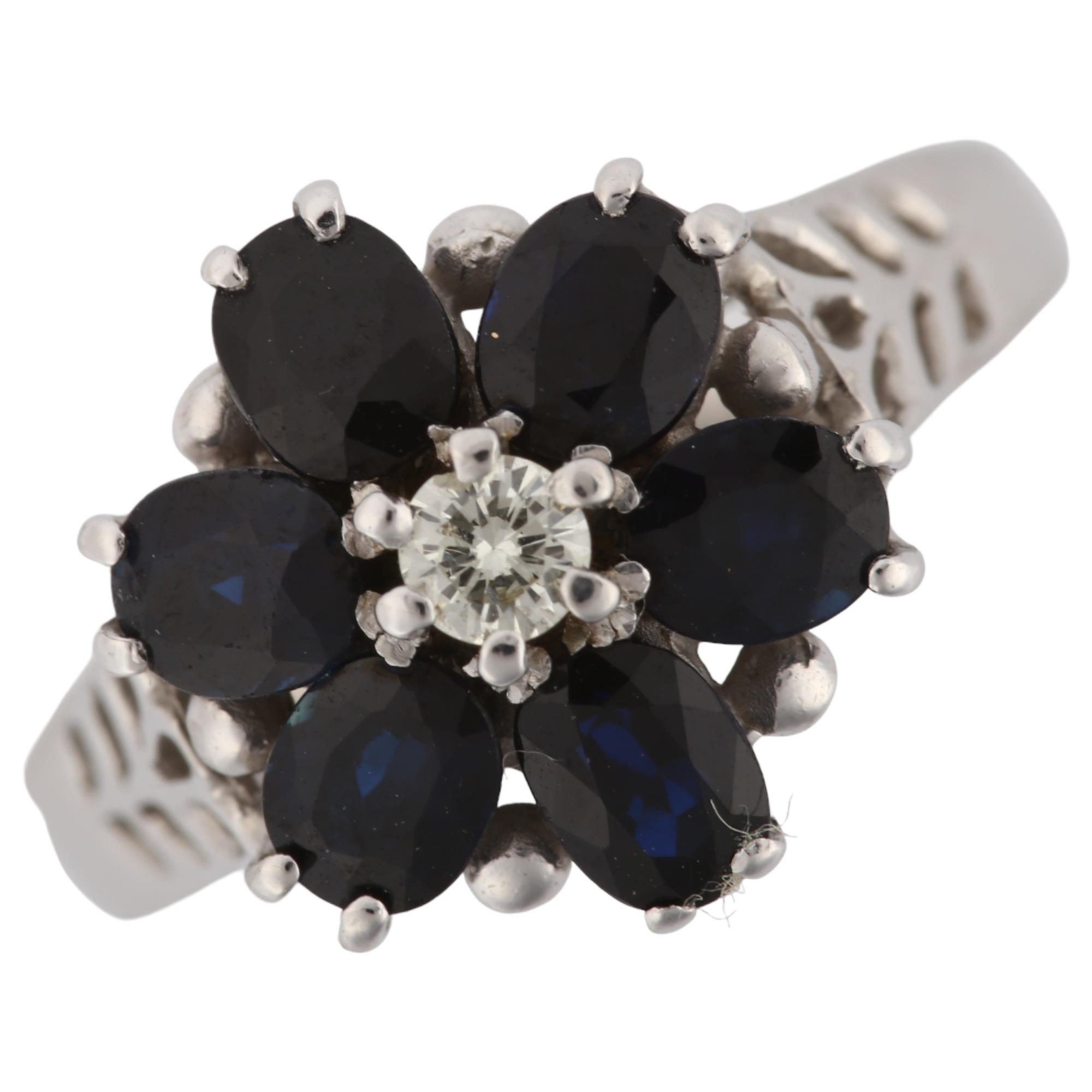 An 18ct white gold sapphire and diamond cluster flowerhead ring, set with oval mixed-cut sapphire