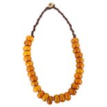 **WITHDRAWN** A Tribal single-strand butterscotch amber bead prayer necklace, bead diameter 19.5mm,