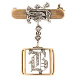 An Art Deco diamond initial drop brooch, unmarked gold settings with rose-cut diamonds and