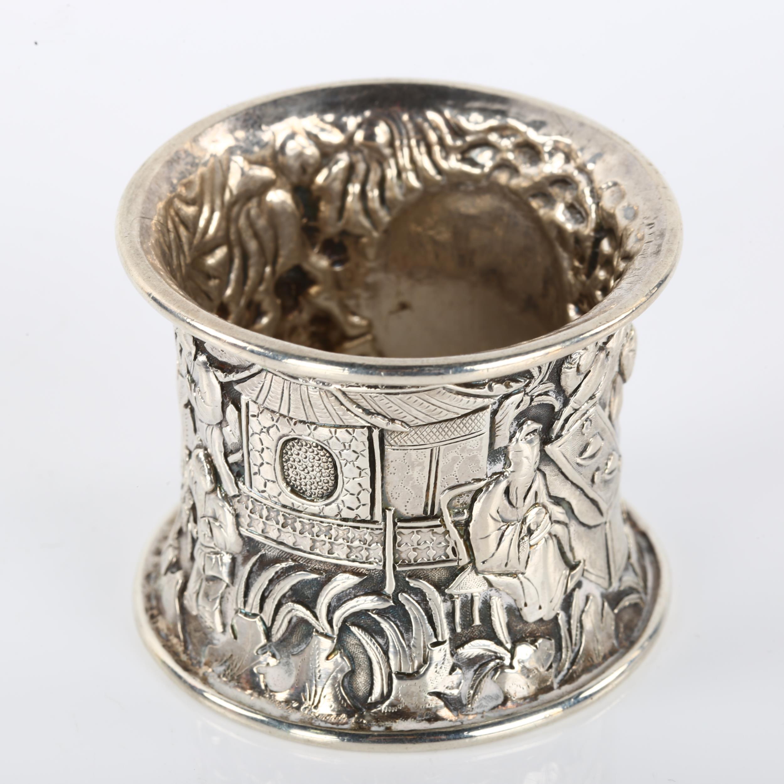 A heavy Chinese export silver napkin ring, relief embossed village scene decoration, circa 1900, - Image 2 of 3