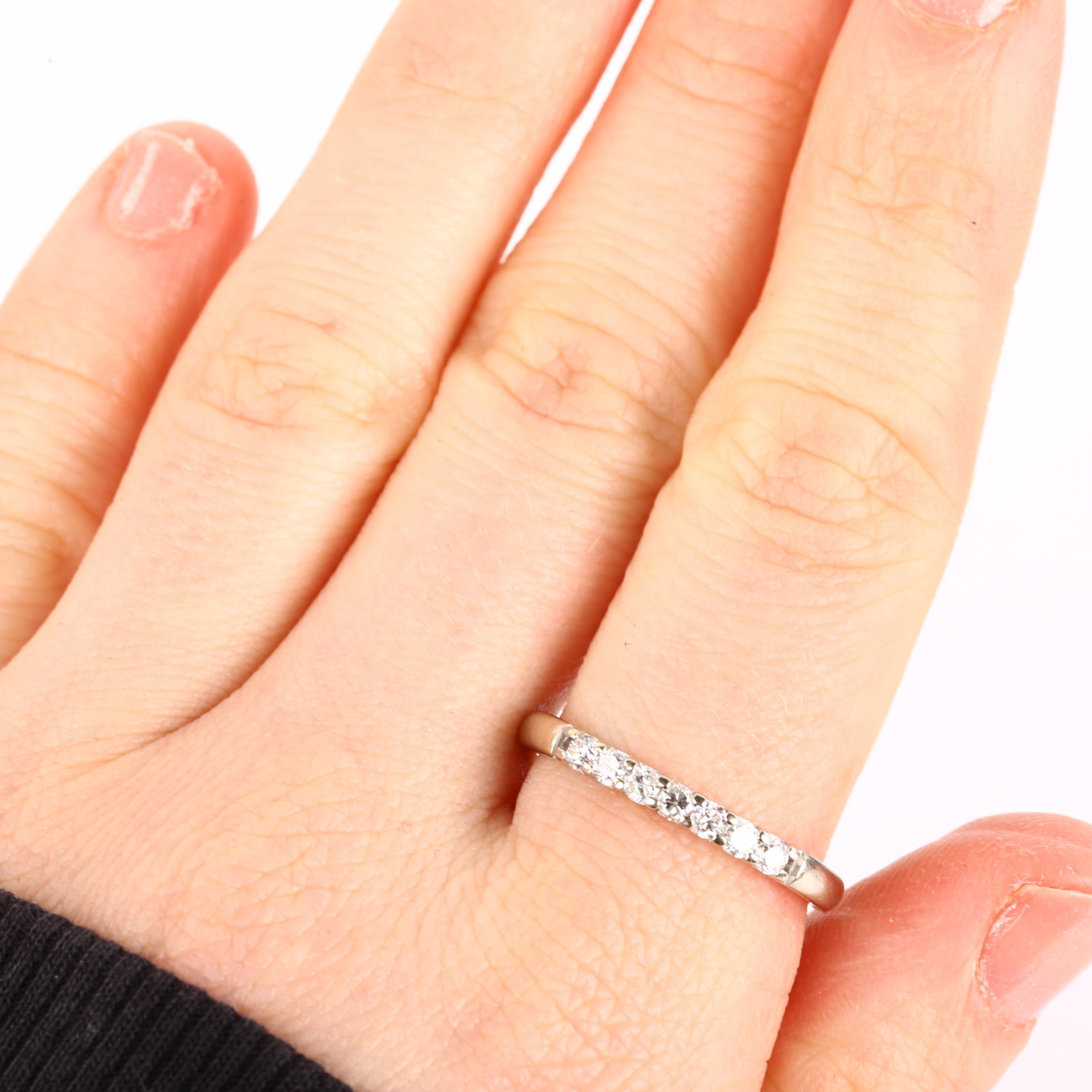 An 18ct white gold seven stone diamond ring, set with modern round brilliant-cut diamonds, total - Image 4 of 4