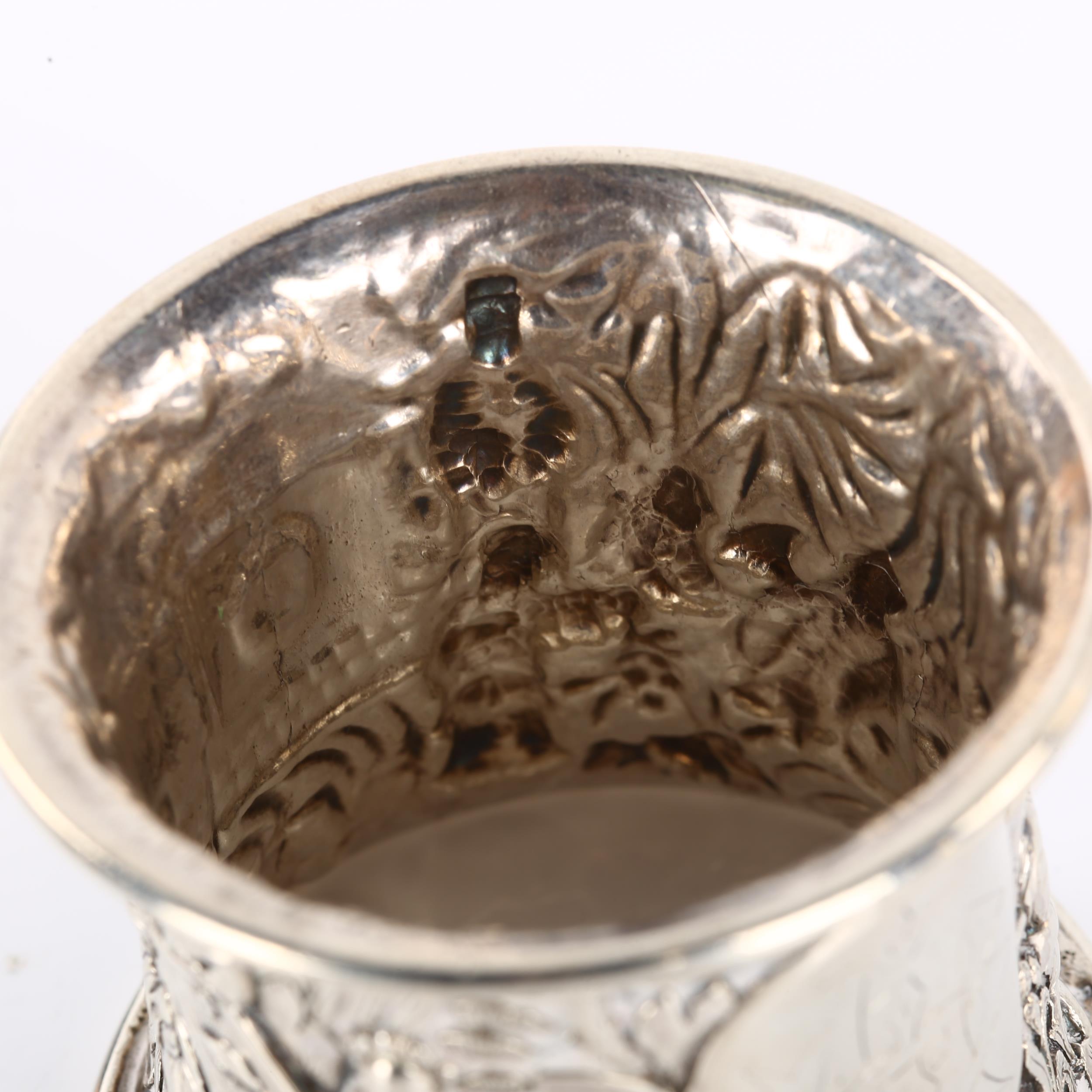 A heavy Chinese export silver napkin ring, relief embossed village scene decoration, circa 1900, - Image 3 of 3
