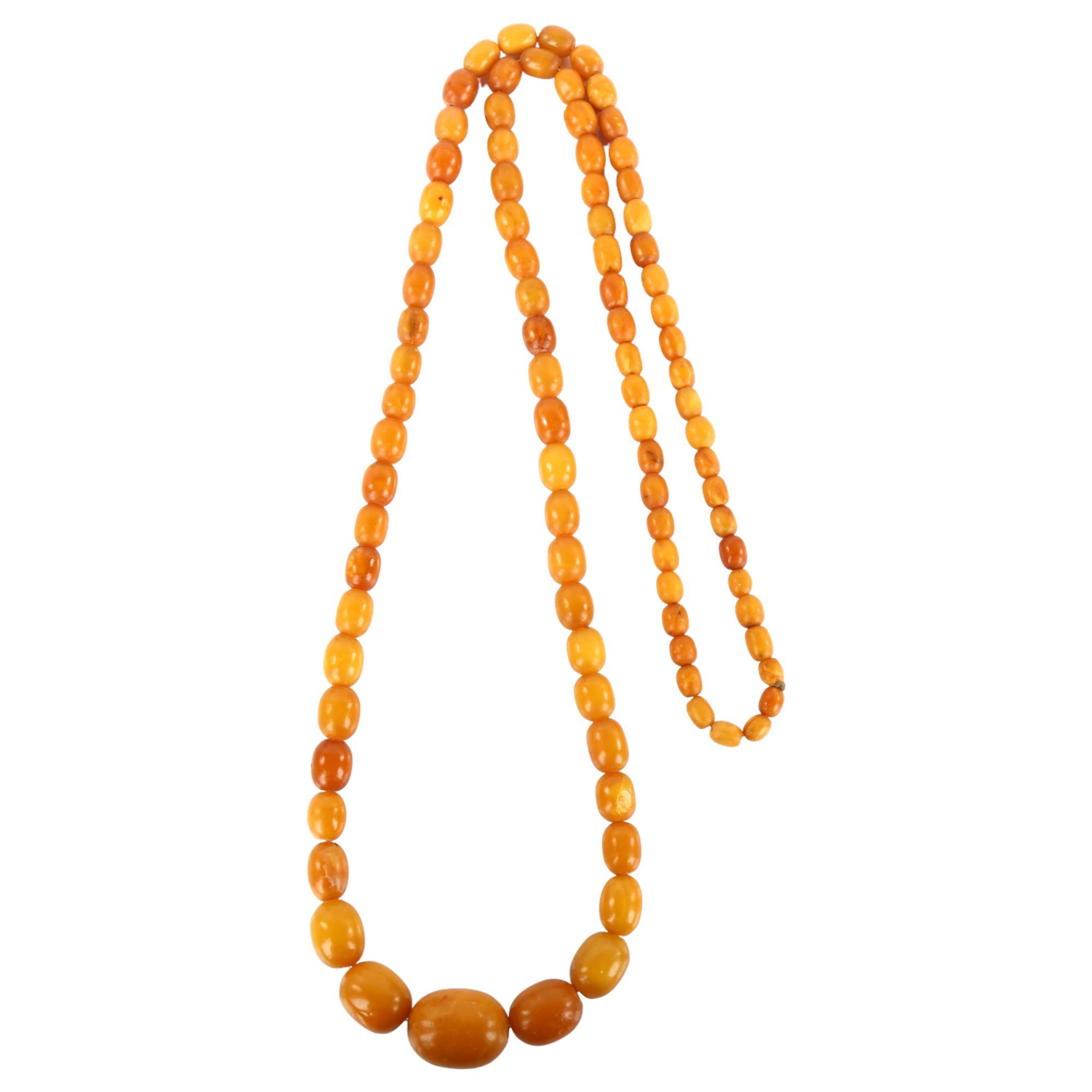A graduated single-strand butterscotch amber bead necklace, bead lengths 22.1-7.0mm, necklace length