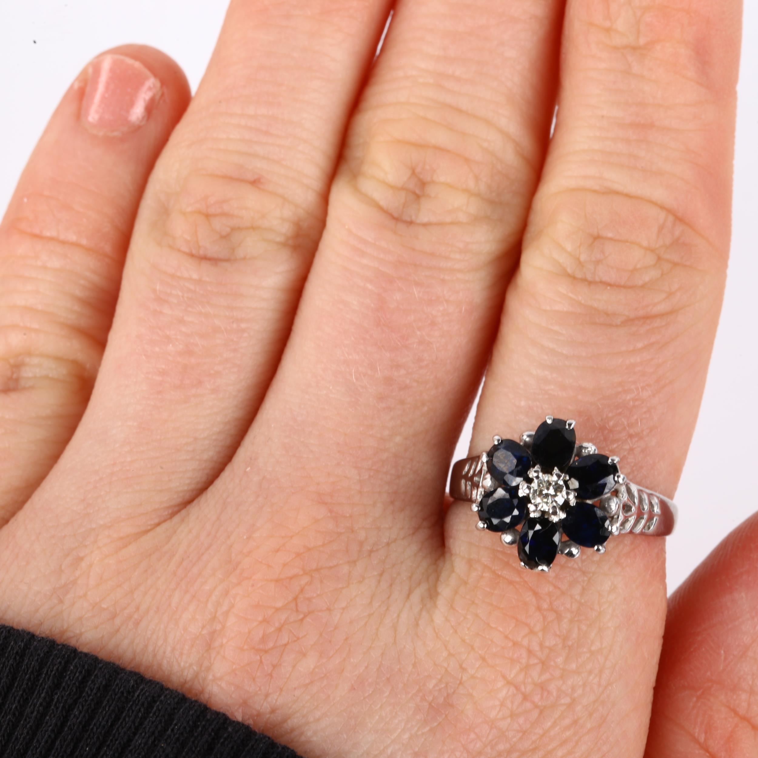 An 18ct white gold sapphire and diamond cluster flowerhead ring, set with oval mixed-cut sapphire - Image 4 of 4