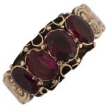 A Victorian 18ct gold four stone garnet half hoop ring, closed-back settings with floral engraved