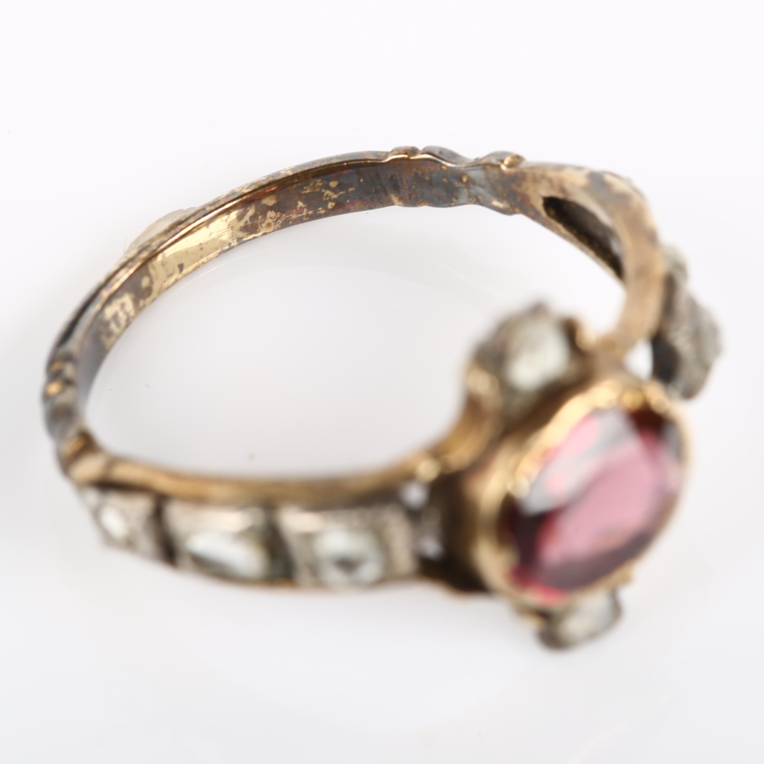 A Georgian garnet and diamond ring, unmarked gold settings with oval mixed-cut garnet and rose-cut - Image 3 of 4