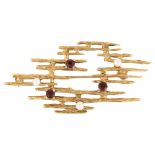 A late 20th century 9ct gold garnet and pearl abstract brooch, textured bark design, maker's marks
