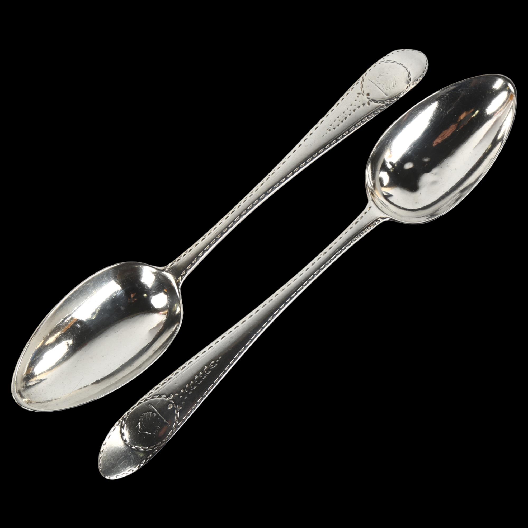 A pair of George III Irish silver serving spoons, with bright-cut engraved decoration, by John