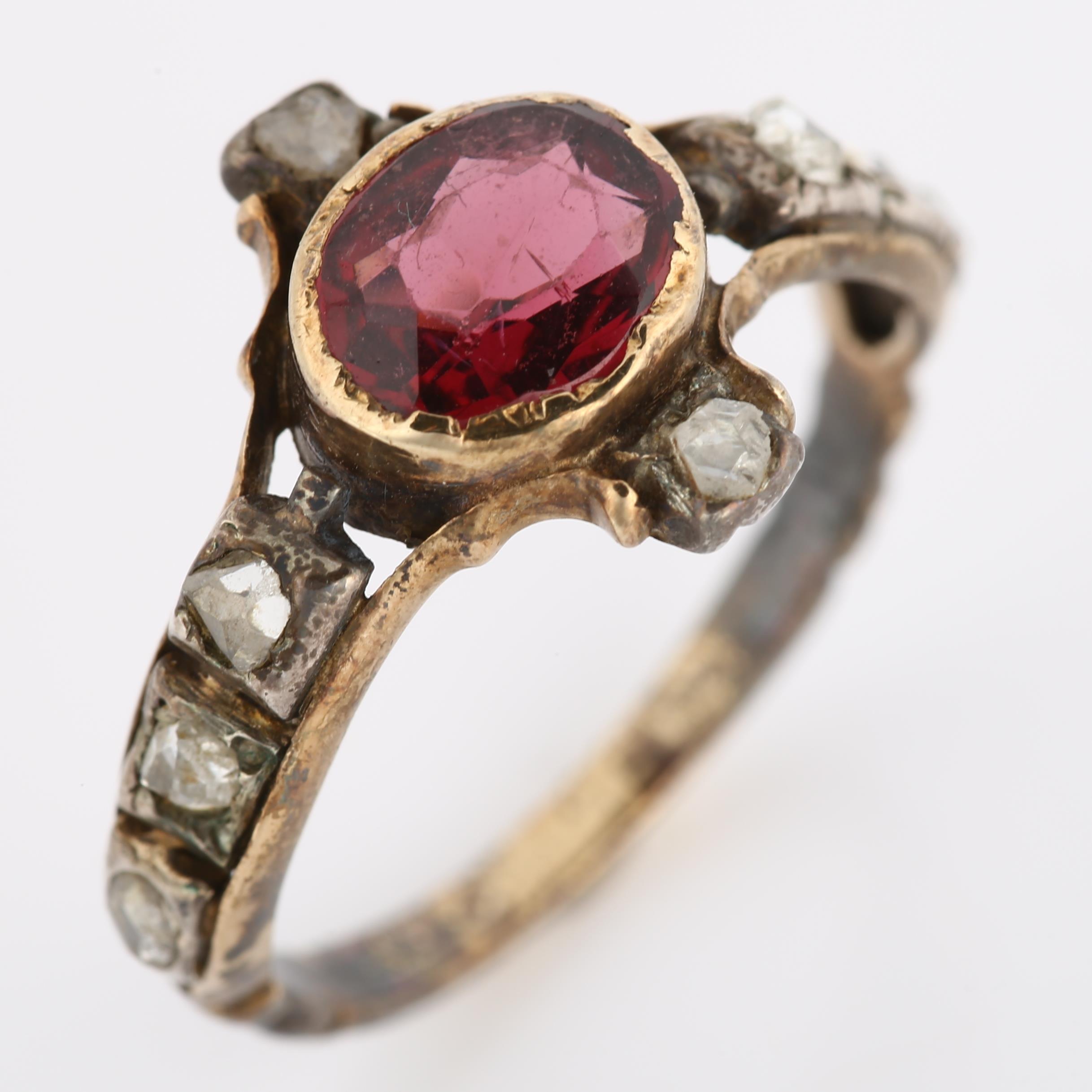 A Georgian garnet and diamond ring, unmarked gold settings with oval mixed-cut garnet and rose-cut - Image 2 of 4