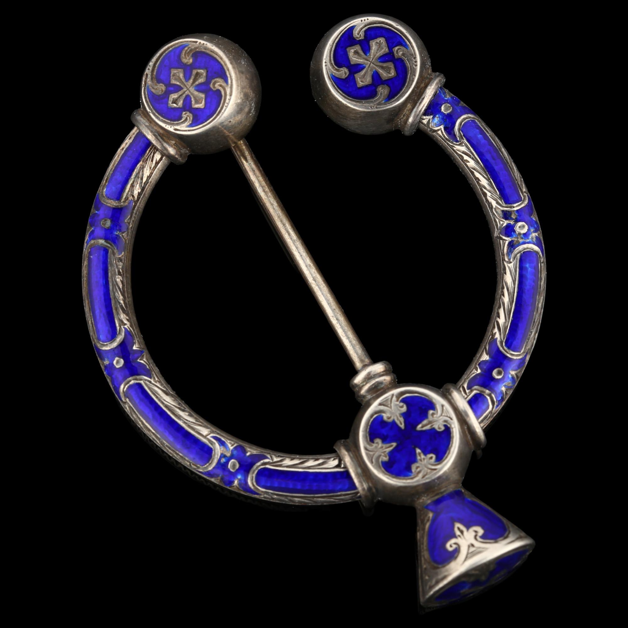 A 19th century Scottish Celtic blue enamel penannular brooch, unmarked silver settings with
