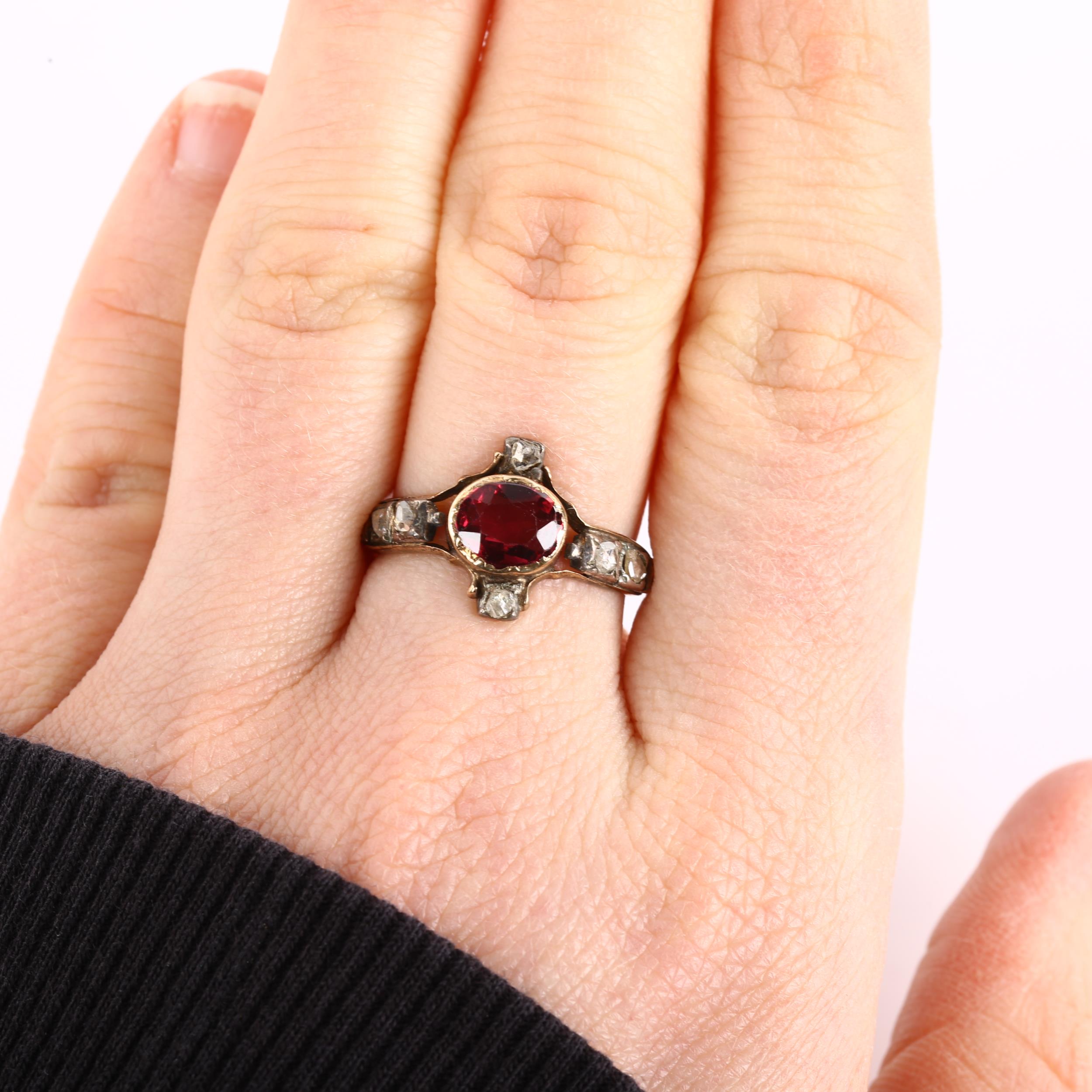 A Georgian garnet and diamond ring, unmarked gold settings with oval mixed-cut garnet and rose-cut - Image 4 of 4