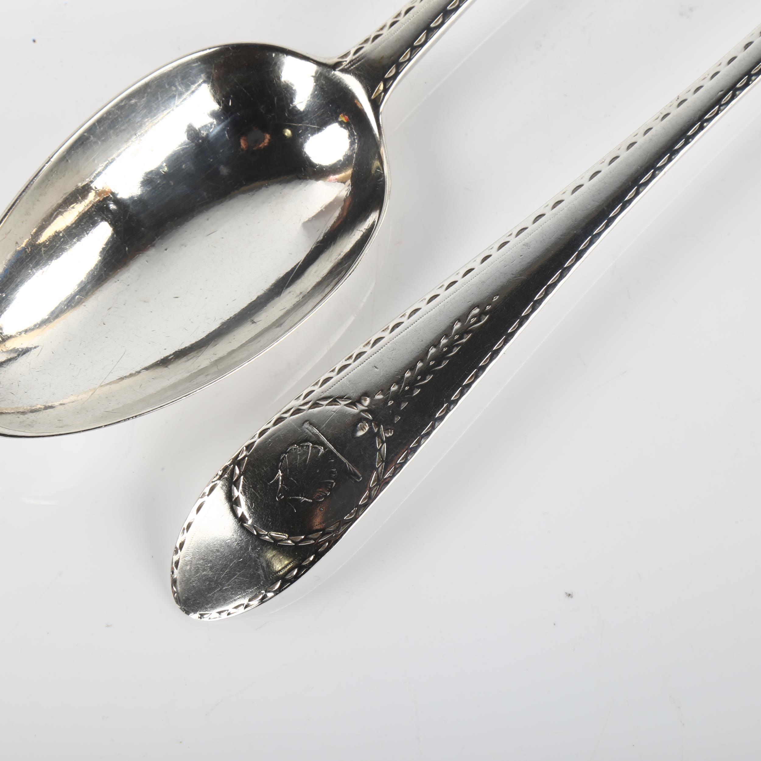 A pair of George III Irish silver serving spoons, with bright-cut engraved decoration, by John - Image 2 of 3