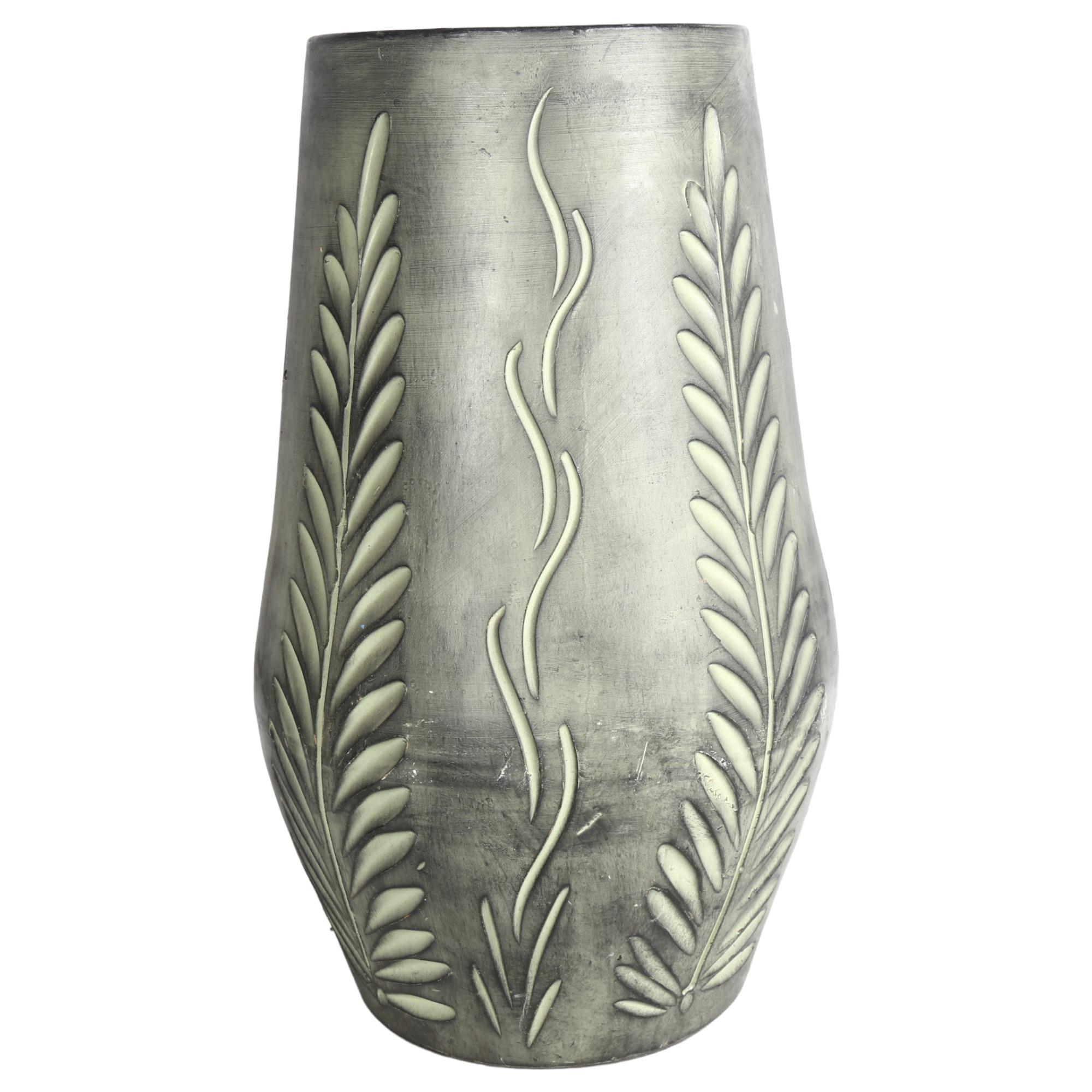 A large green glazed incised pottery vase, with foliate decoration, 48cm