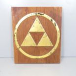 Gaming interest - a brass and teak Legend of Zelda Tri-force wall plaque. 64x76x6cm