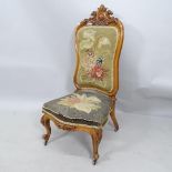 A Victorian walnut and needlework upholstered nursing chair.