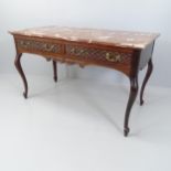 A French mahogany and marble topped side table with two frieze drawers, with carved decoration and
