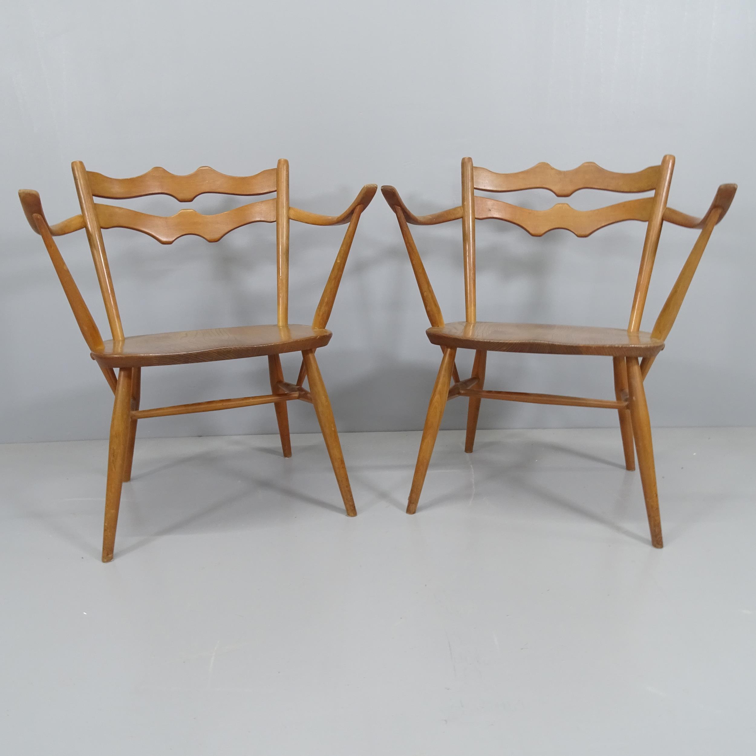 A pair of mid-century Ercol easy chairs in elm and beech.