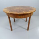 A secessionist style walnut veneered circular dining table with inlaid star decoration, raised on