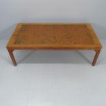 A mid-century rosewood coffee table with inset copper top. 140x45x70cm