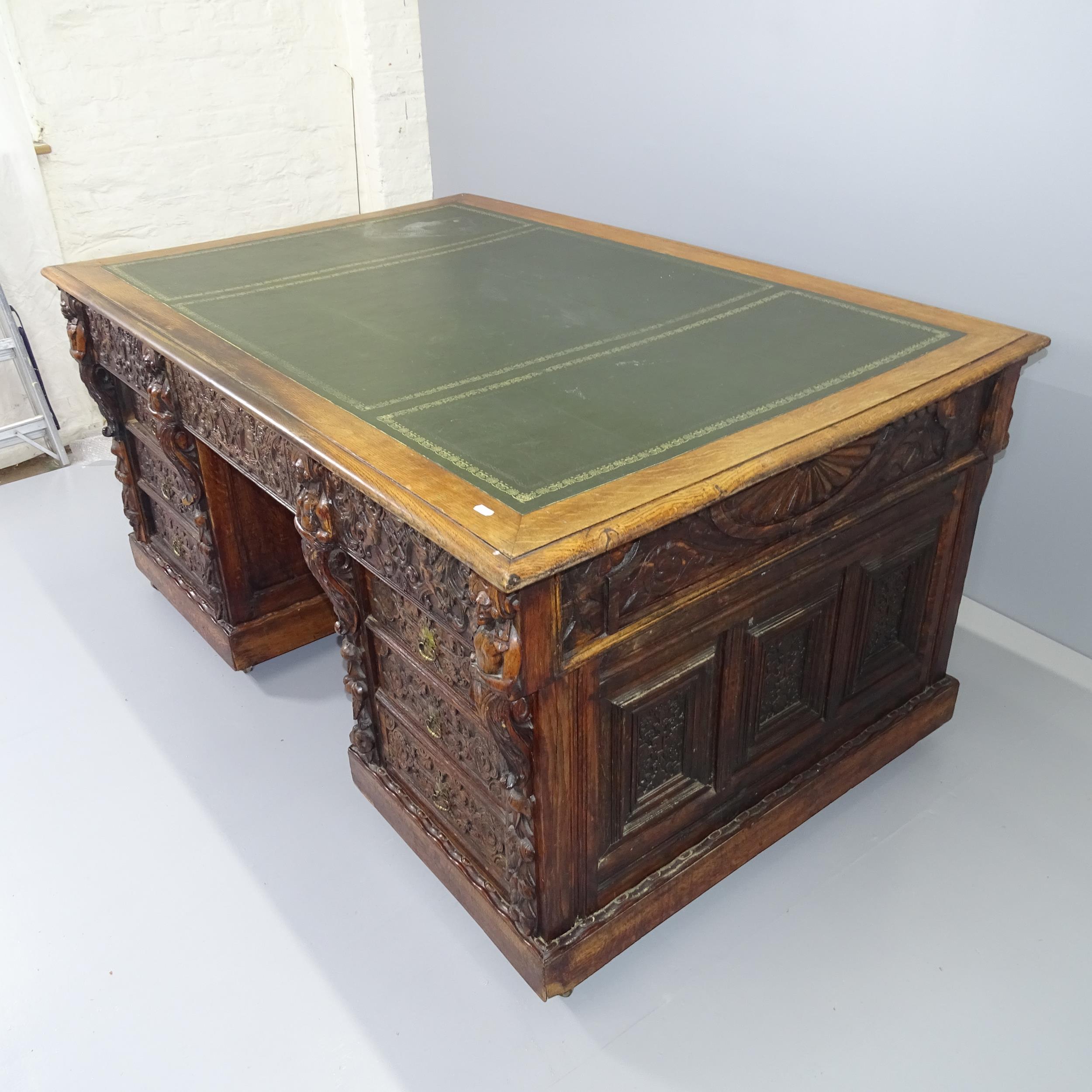 A Victorian carved oak partner's twin pedestal writing desk, woith tooled and embossed green leather - Image 2 of 2