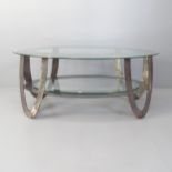 A contemporary oval two tier glass top coffee table with brushed steel frame. 99x43x61cm