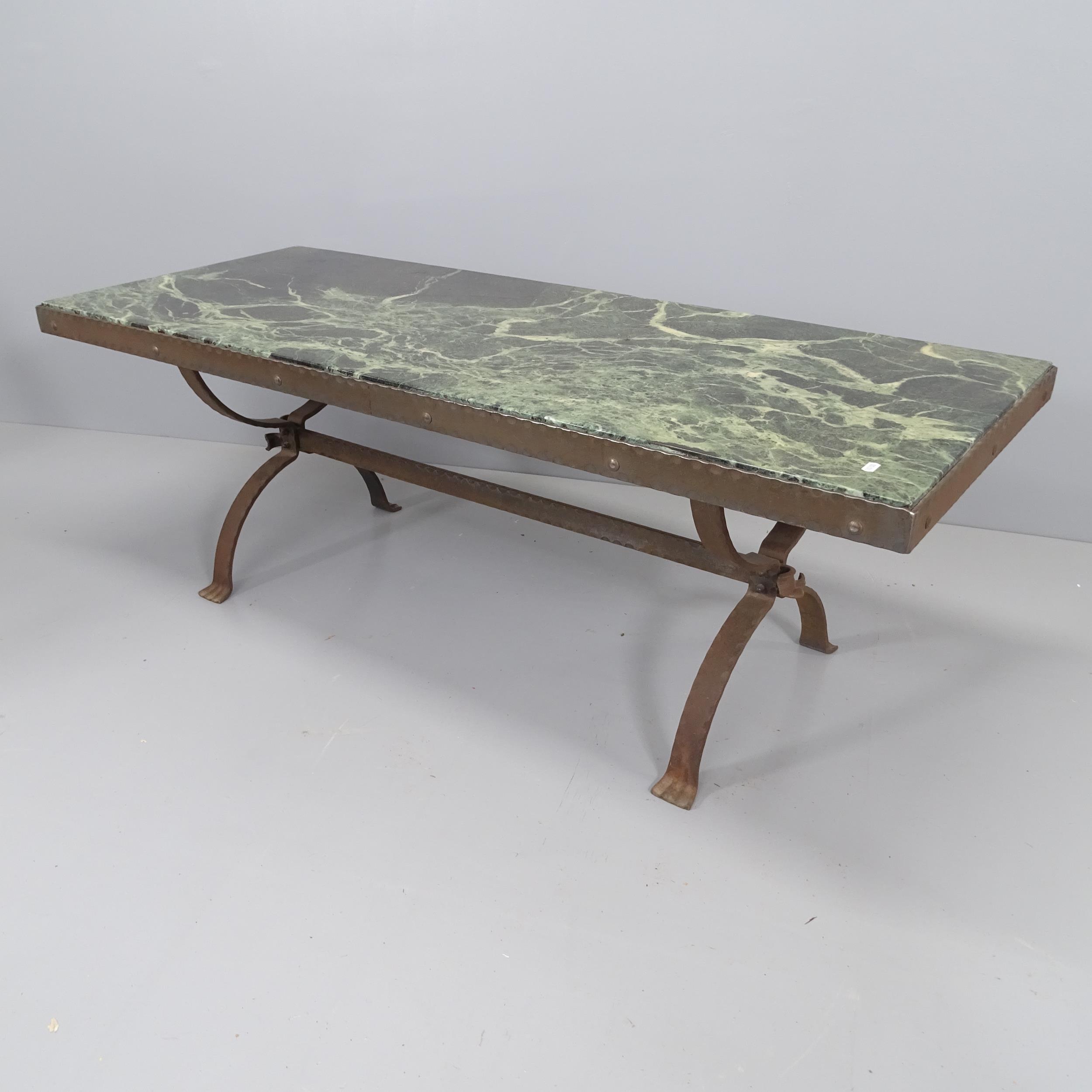 A marble-topped coffee table on cast iron base.148x52x58cm